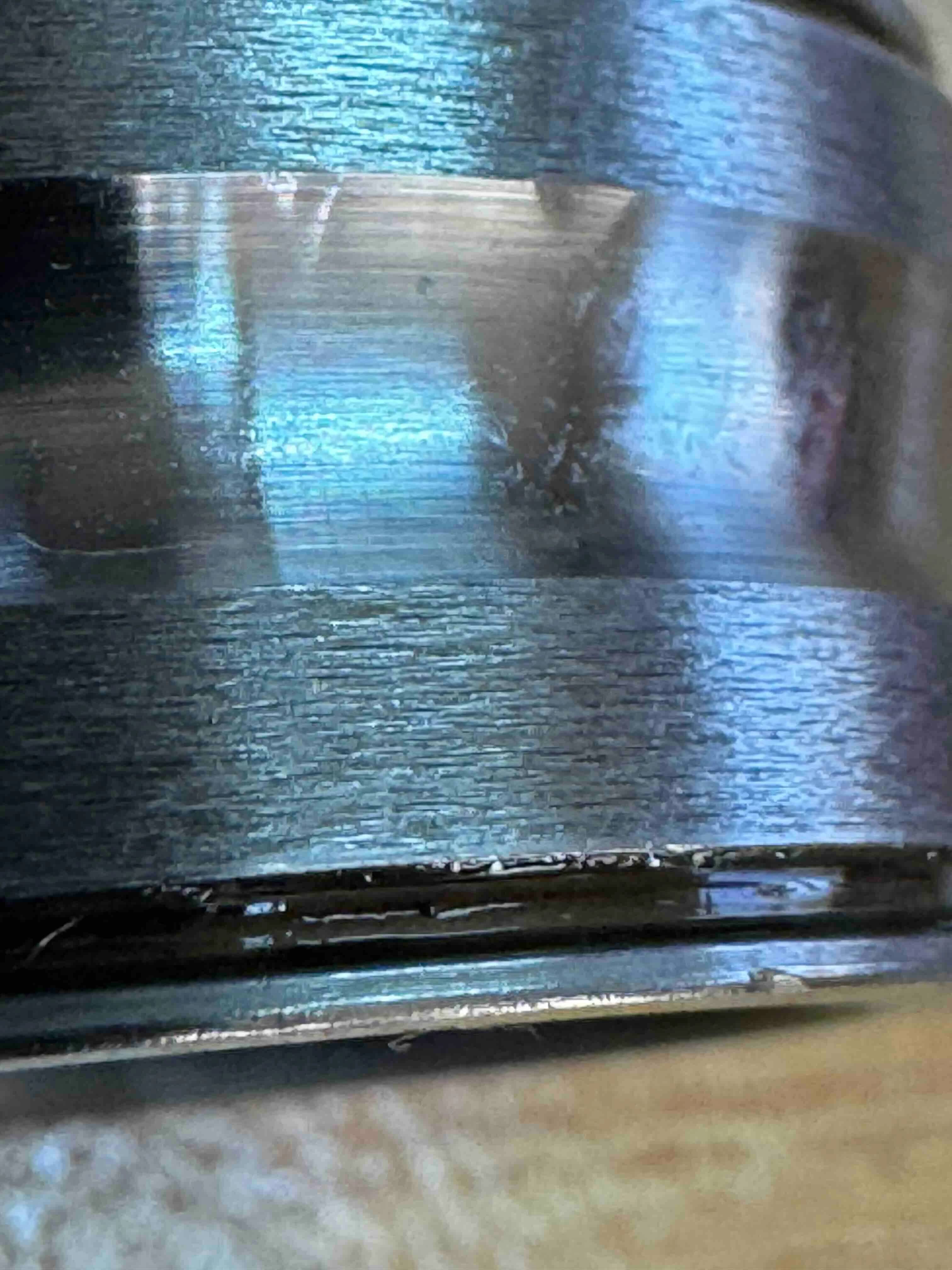 Plastic deformation at the outer edge of a bearing raceway caused by axial overload